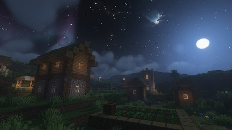 Uma vila de Minecraft durante a noite.
