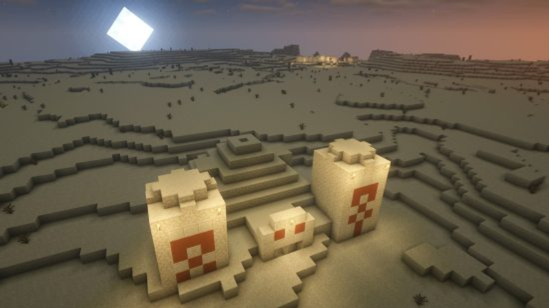Minecraft seeds: Um templo do deserto em primeiro plano, com uma vila no deserto no horizonte.