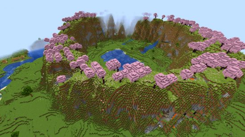 Uma das melhores seeds do Minecraft que já vimos, este local deslumbrante apresenta árvores de cerejeira rosa situadas em um anel de montanhas, circundando um vale com um lago e cavernas.
